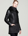 Complexly chic, this Mackage coat layers a leather and shearling vest over a rich wool coat with leather sleeves and a high collar for a look that balances high design with downtown edge.