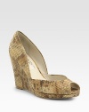 Snake-embossed metallic leather wedge with a low-cut front and subtle peep toe. Self-covered wedge, 5 (125mm)Covered platform, ½ (15mm)Compares to a 4½ heel (115mm)Snake-embossed metallic leather upperLeather liningBuffed leather solePadded insoleImported