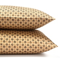 The intricate design of an antique Persian Rug in terracotta, bronze and cream tones inspires these unique Ralph Lauren pillowcases.