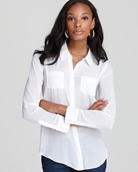 Satiny pockets and trim lend a hint of luxe to this GUESS top that transitions from the office to cocktail hour with effortless chic.