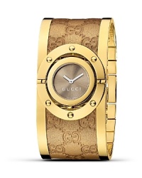 A glamorous watch from Gucci with sun-brushed dial and logo-embossed leather bangle.