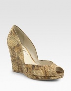 Snake-embossed metallic leather wedge with a low-cut front and subtle peep toe. Self-covered wedge, 5 (125mm)Covered platform, ½ (15mm)Compares to a 4½ heel (115mm)Snake-embossed metallic leather upperLeather liningBuffed leather solePadded insoleImported