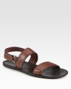 Signature gancini stamped leather shapes this casual slip-on with back buckle strap.Calfskin upperLeather liningPadded insoleRubber soleMade in Italy