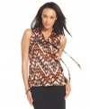 Get on trend with ABG's sleeveless blouse, featuring a bold graphic print and feminine tie-neck detail. (Clearance)