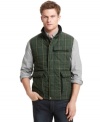 Warm up when it cools down with a touch of plaid and this lightweight puffer vest from Izod.