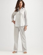 Experience the ultimate in luxury with this smooth cotton sateen two-piece set in a timeless silhouette. Shirt collarLong sleevesButton front closureBack pleatingHigh-low hemElastic waistbandInseam, about 32Laundered cotton sateenMachine washImported