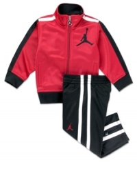 On or off the court, he'll look and feel like a pro superstar in this Jordan track suit by Nike Kids.