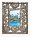 Much to love. This hand carved and hammered picture frame surrounds images of your favorite people with hearts of steel, but also gives hope to the artist, Johnny Simone, and other talented Haitians who depend on their craft.