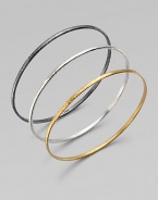 From the Skittle Collection. Three wispy hammered bangles - blackened and white sterling silver and 24k yellow gold - are minimalist in design with impactful results.24k yellow gold Sterling silver Imported