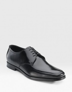 Highly polished Italian spazzolato leather lace-up oxford with an apron toe. Leather lining Padded insole Leather and rubber sole Made in Italy 