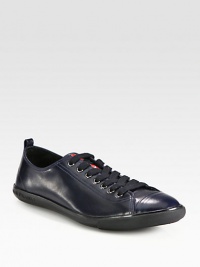 Polished, calfskin leather lace-up design with cap-toe detail and logo-embossed rubber sole for added comfort and support.Ankle pull tabLeather upperLeather liningRubber soleImported