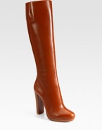 Richly hued leather in a knee-high silhouette with a side zipper, sky-high heel and signature red leather sole. Stacked heel, 4 (100mm)Covered platform, ½ (15mm)Compares to a 3½ heel (90mm)Shaft, 15½Leg circumference, 14Leather upperSide zipperLeather liningSignature red leather solePadded insoleMade in ItalyOUR FIT MODEL RECOMMENDS ordering one size up as this style runs small. 