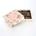 A selection of fine milk and dark chocolates in a delicately printed floral box.