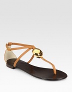 Rich leather t-strap with an adjustable, wrap-around ankle strap and a gleaming goldtone adornment. Leather upperLeather lining and solePadded insoleMade in ItalyOUR FIT MODEL RECOMMENDS ordering true size. 