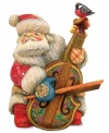 Sounds of the season. A robin sings backup as St. Nick takes to the strings in this exquisitely hand-painted figurine from DeBrekht. Elaborate carvings throughout render the collectible one of a kind.