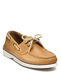 An extra-comfy boat shoe from Ferragamo WORLD, blending classic details like side laces and a gathered moc toe with accents like the chunky contrast rubber sole and 2-tone detail at the heel.