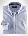 A heritage essential that never goes out of style, the oxford shirt is crafted in Polo's signature tradition, from extra soft combed cotton. This timeless design is tailored for a comfortable, classic fit. Single needle tailoring strengthens the seams and gives a clean look. Button down collar. Back box pleat and split back yoke for comfortable fit.