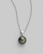 From the South Sea Collection. Elegantly simple with a black, round cultured South Sea pearl hanging from a chain of 18k white gold. 9mm black round cultured pearl Quality: A+ 18k white gold Length, about 18 Spring ring clasp Imported