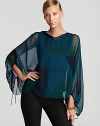 With a cape-like silhouette, Elie Tahari's silk chiffon blouse shows off subtle color blocking.