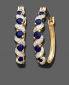 Sultry round-cut sapphire (5/8 ct. t.w.) cascades down these hoop earrings featuring diamond accents in 18k gold over sterling silver. Approximate drop: 3/4 inch. Approximate diameter: 1/2 inch.