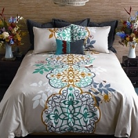 Double décor options, double happiness. The front of our Shangri-la duvet cover set shows a dramatic, oversized medallion motif printed in turquoise, yellow ochre and storm grey on a white and pebble background. Look closely for a bird, a bee, and flowers embroidered in coral. On the reverse, a pattern of white medallions stands like a screen set against storm grey Himalayan slopes. A real Kharma collection.