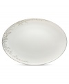 Fringed with shimmering leaves of platinum and mica, this bone china oval platter turns your table into a springtime utopia. Its sleek coupe shape is a vision of modern elegance in platinum-banded white.