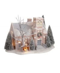 Snow covered and lit from within, Holy Night Church creates a special mood. A bare tree and evergreens sprinkled with snow, along with the Nativity scene in the wooden manger complete a holiday ideal as imagined by Department 56.