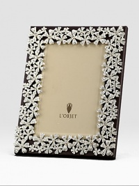 White Swarovski crystals shimmer on the platinum tone floral garland that surrounds this rich leather design.Holds 5 X 7 photoClassic beveled glassStretched leather backingGift boxedImported