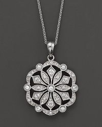 A diamond medallion, set in 14K white gold, makes an unforgettable statement.