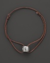 A white gold pendant scattered with diamonds accents this modern leather cord bracelet from Georg Jensen.