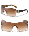 Protect your peepers while looking Tory Burch beautiful. These wrap-around shades are a striking choice.