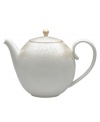 A soft, feminine look with Denby durability, the Lucille Gold teapot promises lasting style and modern grace. In a pattern inspired by vintage lace and designed by English stylemaker, Monsoon, shimmering gold swirls adorn creamy porcelain in this set of dinnerware. The dishes are beautiful for every day and occasion.