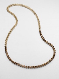 An artistic design with faceted beads on a double link chain. Glass beadsGoldtone brassLength, about 35Slip-on styleImported 