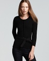 A dark style goes demure as a dainty bow-tie waist crafts a feminine Burberry Brit wool cardigan.