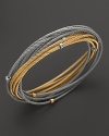 18K yellow and white gold stations accent this mix of cable bangles from Charriol.