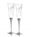 Share your love. Loopy hearts adorn the glass and silver-plated stems of Love Story toasting flutes, an elegant way to toast your new bride or groom. From Mikasa.