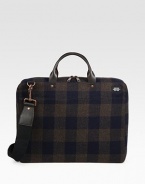 A lightly padded laptop case designed in rugged plaid-check wool with leather handles. Zip closure16L X 12H X 3DImported