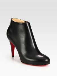 Sleek leather ankle boot distinguished by a stacked heel and convenient side zipper. Stacked heel, 3 (75mm)Leather upperSide zipperLeather liningSignature red leather solePadded insoleMade in ItalyOUR FIT MODEL RECOMMENDS ordering one size up as this style runs small. 