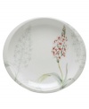 Garnished with the faint outline of flowers and full-color blooms, this simple coupe-shaped accent plate cultivates sunny, casual meals in any setting. (Clearance)