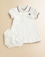 Soft, airy pique knit with sporty stripes, perfect for your future tennis star.Ribbed polo collar with two-color striped tippingShort sleeves with ribbed, tipped cuffsButton placketLogo appliqué at chestBox pleated hemMatching bloomers with elasticized waist and leg openings96% cotton/4% elastaneMachine washImported Please note: Number of buttons may vary depending on size ordered. 