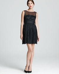 A sheer neckline lends allure to a classic dress in ladylike lace. From Trina Turk.