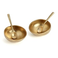 Gleaming in gold, these salt and pepper cellars from Donna Karan Lenox add a dose of organic glamour to the table.