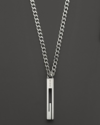 A sterling silver chain bears a Gucci logo pendant.