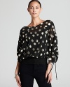 Gilded polka dots dance across a billowing Shiloh 770 top for a playful yet polished style statement.