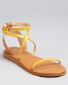 Exotic, snake embossed leather is splashed in a sunny marigold hue on the Rosemary sandals--a low-key flat for warm-weather adventures. From KORS Michael Kors.