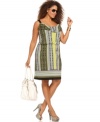 A ruffled neckline lends feminine flair to Style&co.'s sleeveless plus size dress, accentuated by a blouson waist.