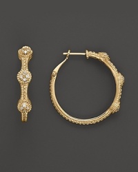 18K gold hoops sparkle with round diamond pave stations. By Judith Ripka.