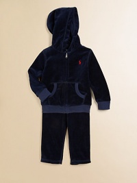 This coordinating athletic set includes a classic full-zip hoodie and a matching sweatpant in soft, cozy velour. Hoodie Attached hoodLong sleevesFull-zip frontSplit kangaroo pocketRibbed cuffs and hem Sweatpants Elasticized waist with tieMock fly87% cotton/13% polyesterMachine washImported