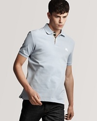 The classic fit polo from Burberry, accented tastefully with a check pattern inside the button placket and an embroidered logo at the left chest.