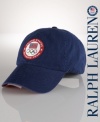 Finished with an embroidered flag shield patch, this cotton twill sport cap celebrates Team USA's participation in the 2012 Olympics.